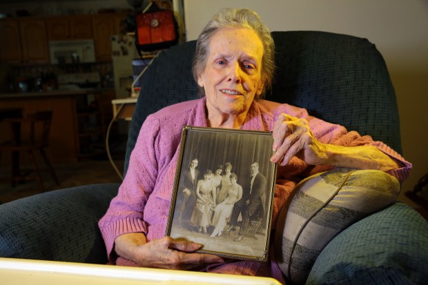 Patricia Anderson, the niece of Chicago White Sox third baseman Buck Weaver, holds up a photo of her uncle at her home in Kimberling City, Mo., on May 17, 2015. (John Owens/Chicago Tribune)