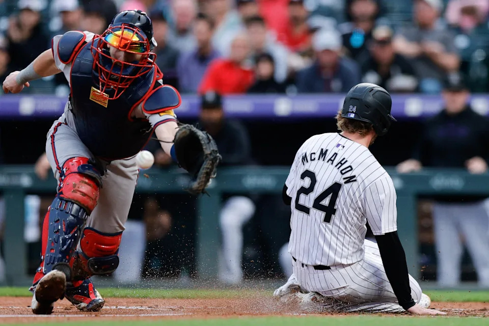 Aug 9, 2024; Denver, Colorado, USA; Colorado Rockies third baseman Ryan McMahon (24) slides home against Atlanta Braves catcher Sean Murphy (12) in the third inning at Coors Field.Isaiah J&period; Downing-USA TODAY Sports