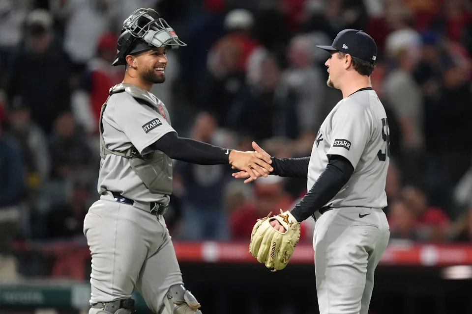 May 28, 2025; Anaheim, California, USA; New York Yankees relief pitcher Mark Leiter Jr. (56) and catcher J.C. Escarra (25) celebrate at the end of the game against the Los Angeles Angels at Angel Stadium. Mandatory Credit: Kirby Lee-Imagn Images