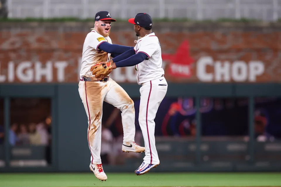 May 5, 2025; Atlanta, Georgia, USA; Atlanta Braves left fielder Alex Verdugo (8) and second baseman Ozzie Albies (1) celebrate after a victory over the Cincinnati Reds at Truist Park.Brett Davis-Imagn Images