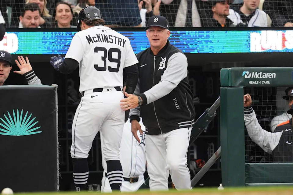 Tigers manager A.J. Hinch, right, congratulates Zach McKinstry, left, after he scored a run.