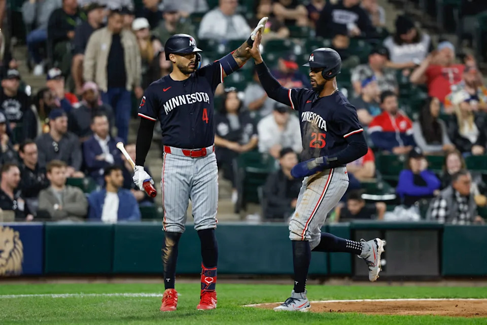 Apr 30, 2024; Chicago, Illinois, USA; Minnesota Twins outfielder Byron Buxton (25) celebrates with shortstop Carlos Correa (4) after scoring against the Chicago White Sox during the ninth inning at Guaranteed Rate Field. Kamil Krzaczynski-Imagn Images