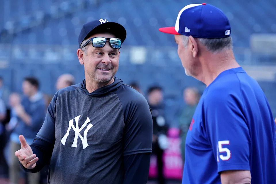 May 20, 2025; Bronx, New York, USA; New York Yankees manager Aaron Boone (17) talks to Texas Rangers manager Bruce Bochy (15) before a game at Yankee Stadium.