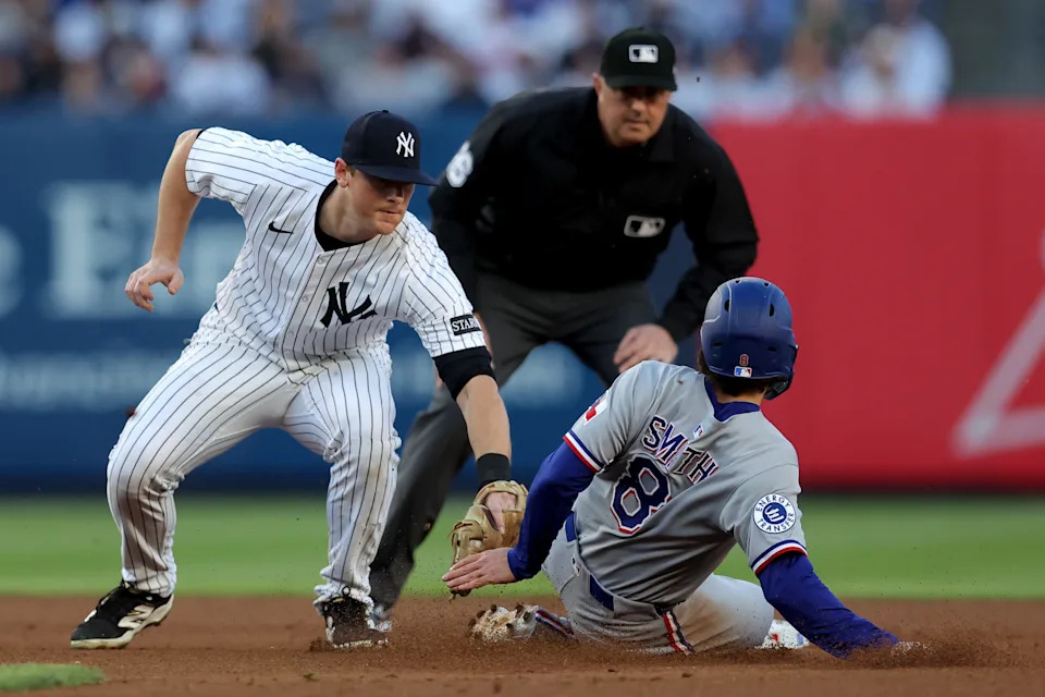 May 20, 2025; Bronx, New York, USA; New York Yankees second baseman DJ LeMahieu (26) tags out Texas Rangers shortstop Josh Smith (8) trying to steal second base during the first inning at Yankee Stadium.