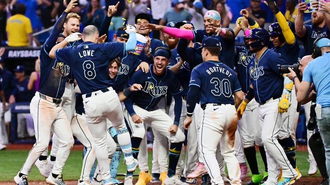 ST PETERSBURG, FLORIDA - JUNE 11: Brandon Lowe #8 of the Tampa Bay Rays celebrates with teammates after hitting a three-run home run in the ninth inning to beat the Chicago Cubs 5-2 at Tropicana Field on June 11, 2024 in St Petersburg, Florida.