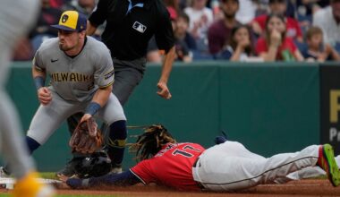 Cleveland Guardians' Jose Ramirez, right, steals third base as Milwaukee Brewers third baseman Caleb Durbin, left, waits for the throw in the fourth inning of a baseball game in Cleveland, Monday, May 12, 2025. (AP Photo/Sue Ogrocki)
