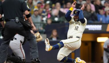 Milwaukee Brewers' Rhys Hoskins (12) slides into home to score during the second inning of a baseball game against the Baltimore Orioles, Monday, May 19, 2025, in Milwaukee.