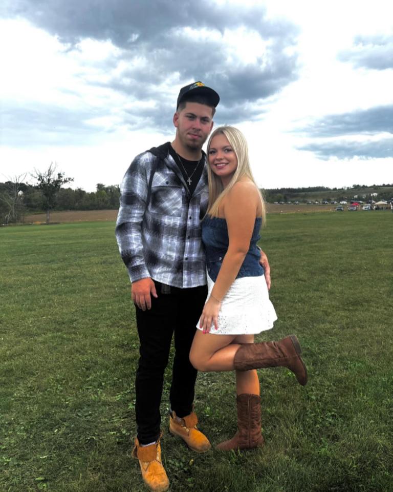 Young couple posing outdoors.