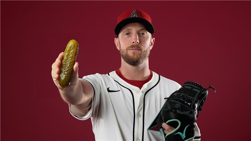 Graphic: D-backs starting pitcher Merrill Kelly holds a pickle...