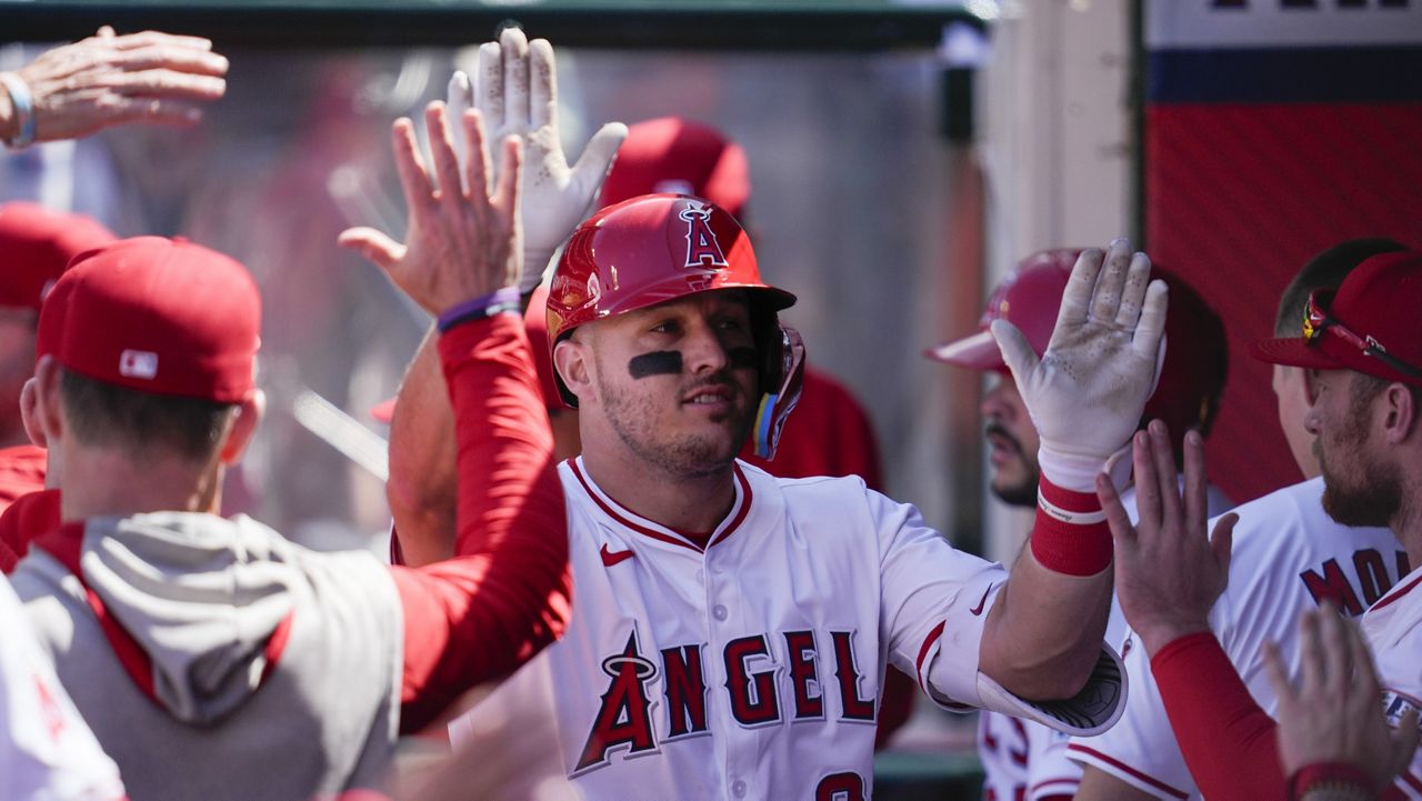Los Angeles Angels designated hitter Mike Trout celebrates in the dugout after hitting a home run during the sixth inning of a baseball game against the Baltimore Orioles in Anaheim, Calif., Wednesday, April 24, 2024. (AP Photo/Ashley Landis)