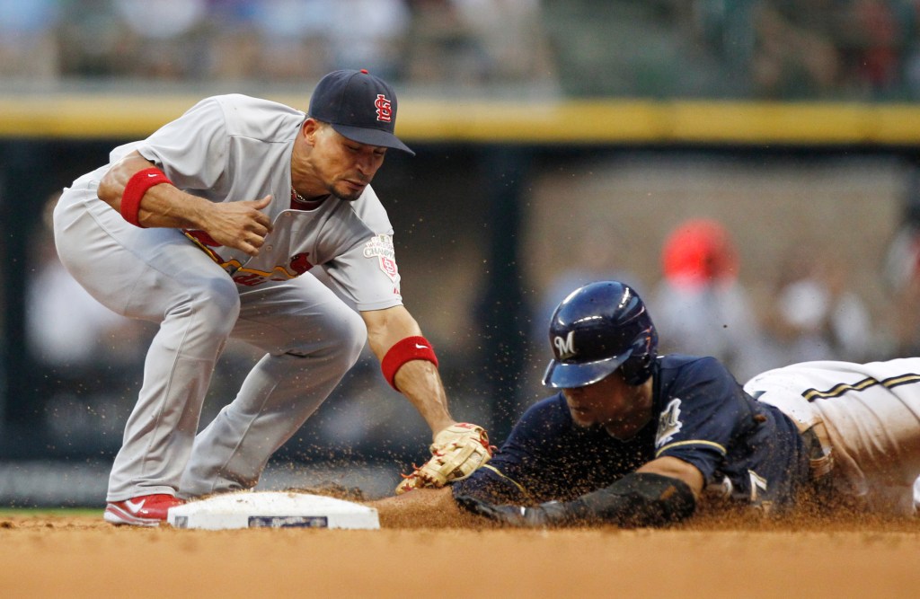 ardinals' Rafael Furcal, left, tags out Milwaukee Brewers' Carlos Gomez during a 2012 game.