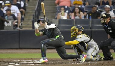 Tampa Bay Rays' Taylor Walls, left, hits a single during the third inning of a baseball game against the Milwaukee Brewers, Friday, May 9, 2025, in Tampa, Fla. (AP Photo/Jason Behnken)