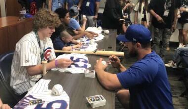 Young patients sign autographs for Cubs players at Wrigley Field