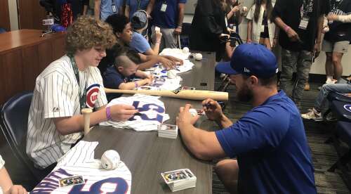 Young patients sign autographs for Cubs players at Wrigley Field