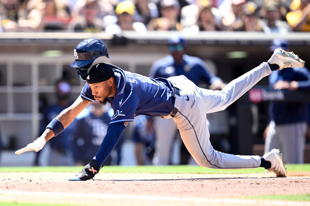 Chandler Simpson of Tampa Bay Rays sliding home to score a run during a match against San Diego Padres at Petco Park