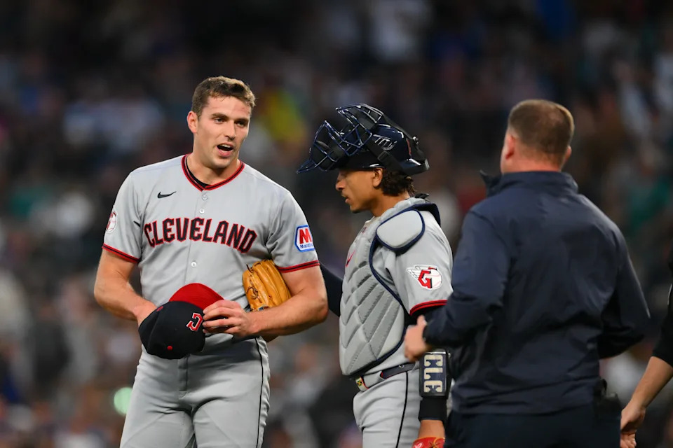 Cleveland Guardians relief pitcher Cade Smith (36) is checked on after being hit by a ball against the Seattle Mariners on June 13, 2025, in Seattle, Washington.