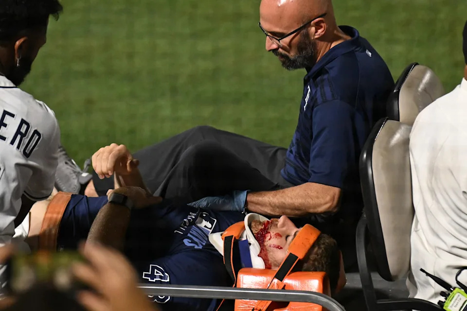 Tampa Bay Rays pitcher Hunter Bigge (43) gets medical attention after getting hit in the face by a foul ball in the seventh inning.