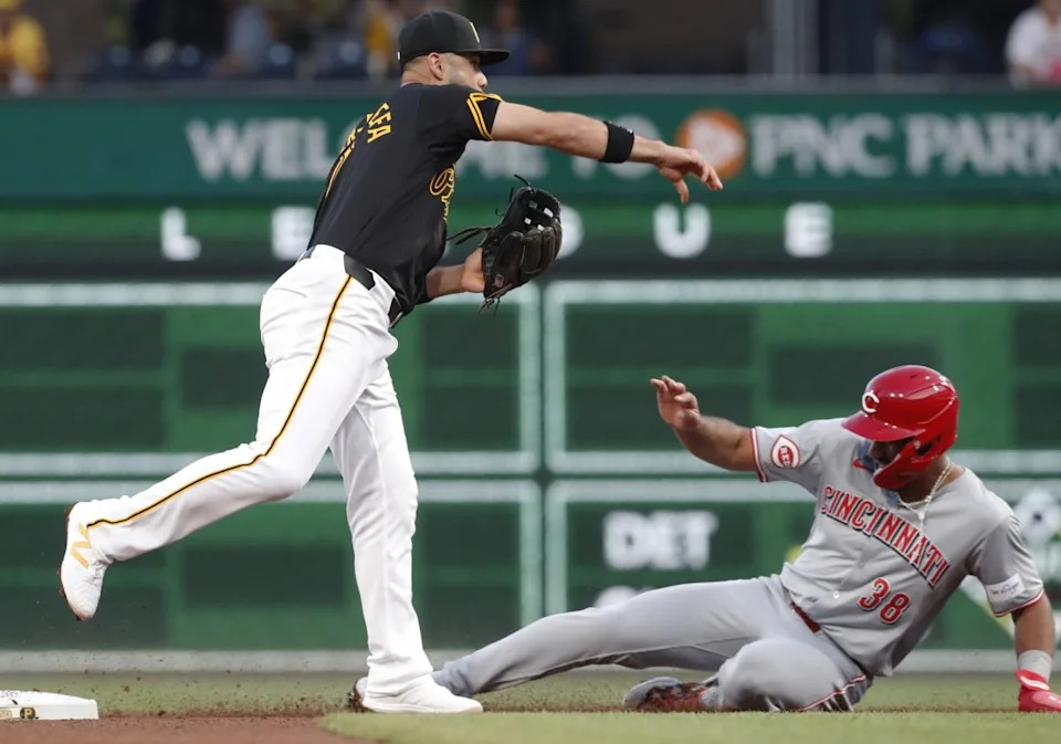 Aug 22, 2024; Pittsburgh, Pennsylvania, USA; Pittsburgh Pirates third baseman Isiah Kiner-Falefa (7) throws to first base to complete a double play over Cincinnati Reds right fielder Amed Rosario (38) during the fifth inning at PNC Park. Mandatory Credit: Charles LeClaire-USA TODAY SportsCharles LeClaire-USA TODAY Sports