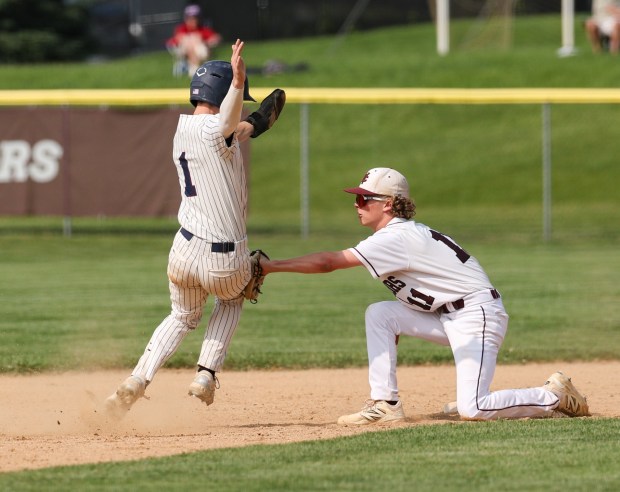 West Chester Henderson's Sam Prior tags out Liberty's Jackson Donatelli at third base on Monday. Photo by Tom Silknitter.