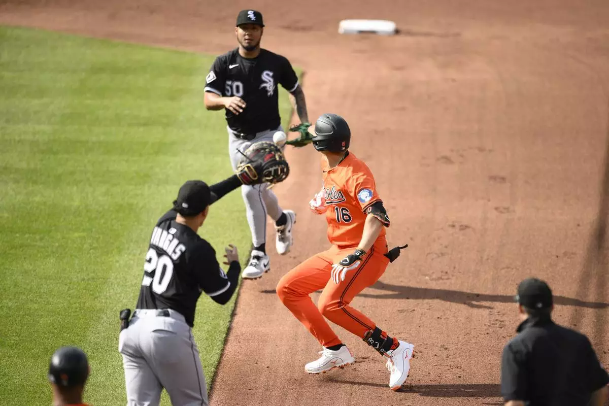 Baltimore Orioles' Coby Mayo (16) is caught in a rundown by Chicago White Sox first baseman Miguel Vargas (20) and second baseman Lenyn Sosa (50) during the fourth inning of a baseball game, Saturday, May 31, 2025, in Baltimore. (AP Photo/Nick Wass)