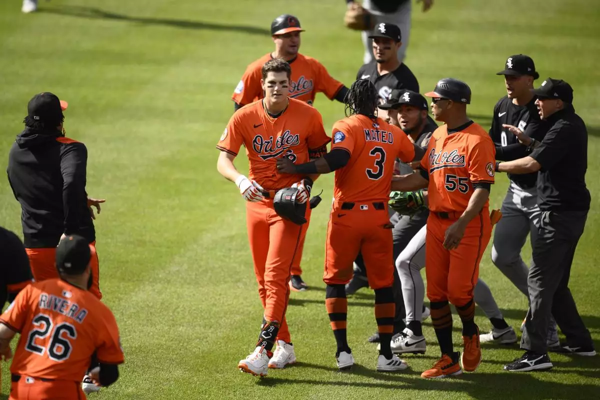 Baltimore Orioles Jorge Mateo (3) separates Coby Mayo, center left, and members of the Chicago White Sox during the fourth inning of a baseball game, Saturday, May 31, 2025, in Baltimore. (AP Photo/Nick Wass)