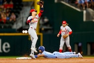 Texas Rangers second baseman Marcus Semien (2) steals second base ahead of the tag from St....