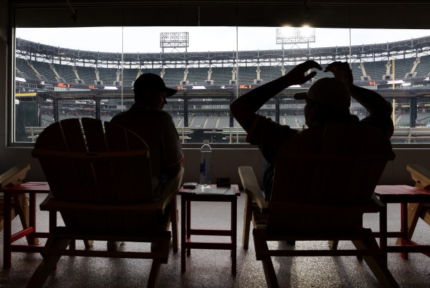 Two fans relax in the Leinenkugel's Craft Lodge beyond right field before a game between the Chicago White Sox and the Detroit Tigers at Rate Field on June 3, 2025. (Chris Sweda/Chicago Tribune)