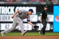Texas Rangers shortstop Corey Seager fields a ball hit by Washington Nationals' Amed Rosario...