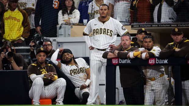 San Diego Padres' Martin Maldonado, Fernando Tatis Jr. and Manny Machado look on in the 10th inning against the Los Angeles Dodgers at Petco Park on Monday, June 9, 2025 in San Diego, CA. (Meg McLaughlin / The San Diego Union-Tribune)