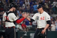 Texas Rangers pitcher Robert Garcia (62) celebrates after the final out with catcher Jonah...