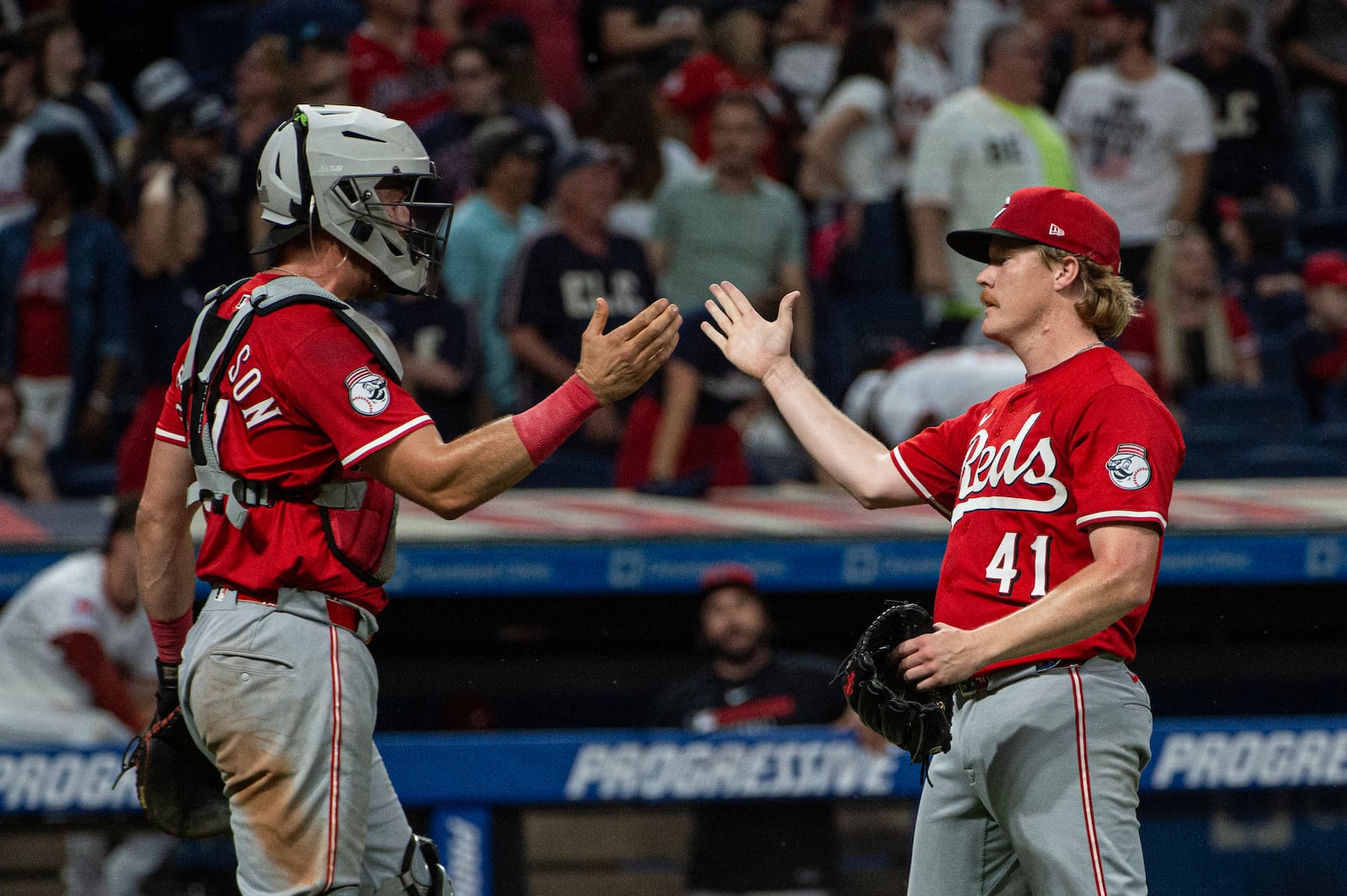 Cincinnati Reds' Tyler Stephenson, left, congratulates Andrew Abbott (41) for his complete game win over the Cleveland Guardians at the end of a baseball game, Tuesday, June 10, 2025, in Cleveland. (AP Photo/Phil Long)