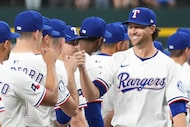 Texas Rangers pitcher Jacob deGrom fist bumps teammates during introductions before an...