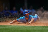 Texas Rangers' Josh Smith slides at home plate to score on a two-run single by Corey Seager...