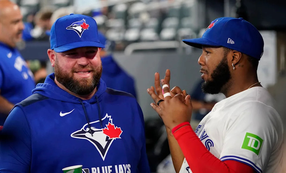 Blue Jays manager John Schneider and first baseman Vladimir Guerrero (27).John E&period; Sokolowski-Imagn Images