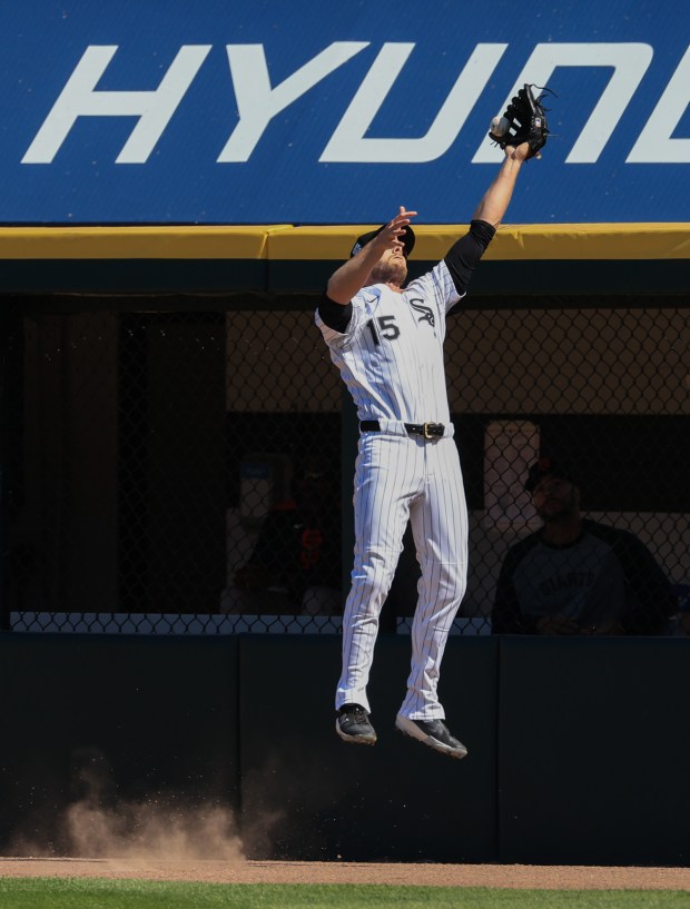 White Sox right fielder Austin Slater leaps to catch what would have been a home run ball hit by Giants center fielder Jung Hoo Lee in the second inning at Rate Field on June 28, 2025, in Chicago. (John J. Kim/Chicago Tribune)