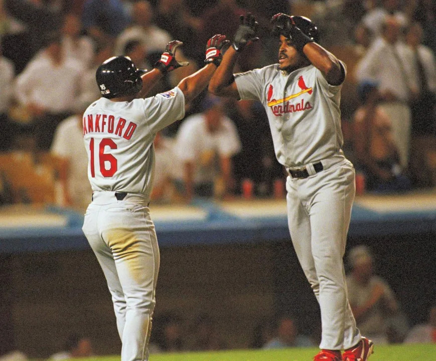 The St. Louis Cardinals Ray Lankford, left, and Brian Jordan celebrate at home plate after they scored the go-ahead runs on teammate Gary Gaetti?s ninth inning double on Tuesday, April 22, 1997 at Dodger Stadium in Los Angeles. The Cardinals scored three runs in the top of the ninth inning to pull out the victory, 6-4. (AP Photo/Chris Pizzello)