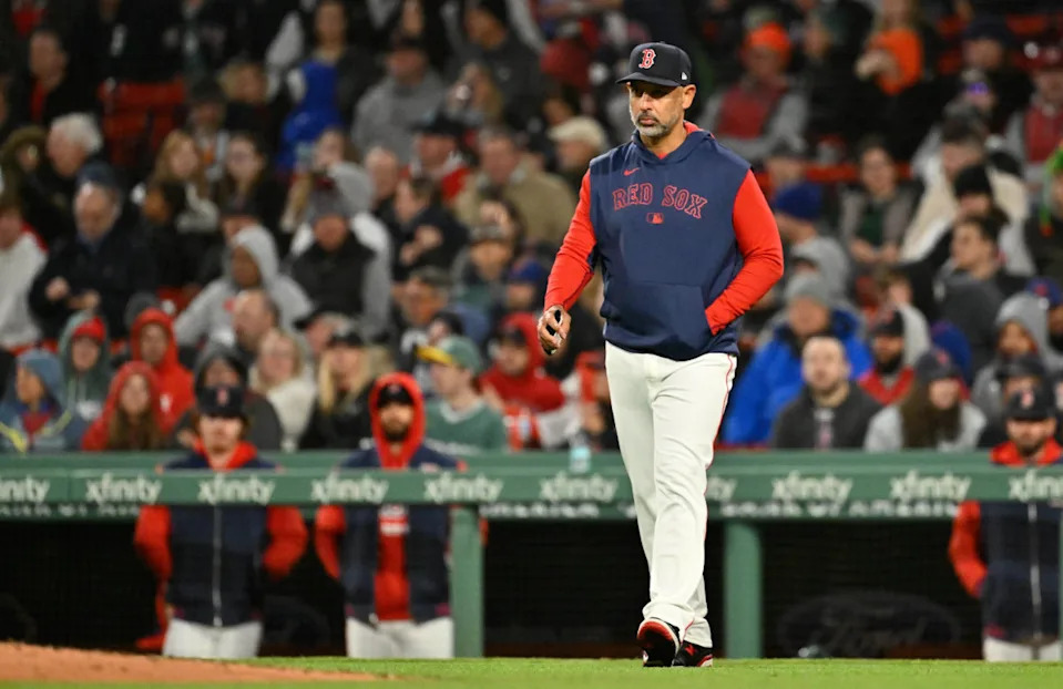 Boston Red Sox manager Alex Cora (13) walks to the mound during the sixth inning against the New York Mets at Fenway Park.Eric Canha-Imagn Images