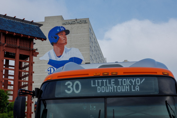 A giant mural of Shohei Ohtani, being painted by artist Robert Vargas on the side of a hotel in Little Tokyo, a neighborhood in downtown Los Angeles, is shown ahead of Shohei Ohtani’s opening game and season with his new team the Los Angeles Dodgers in Los Angeles, California, the United States on March 20,2024.