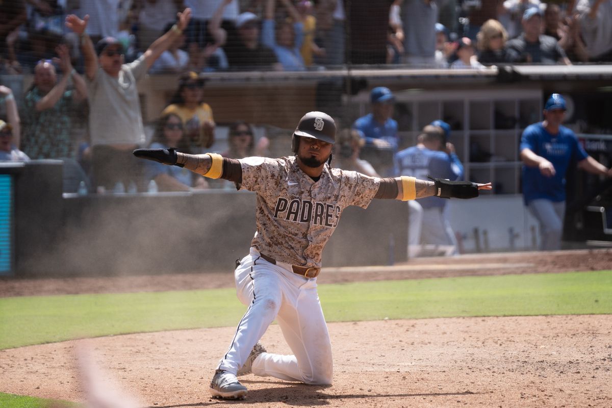 San Diego Padres infielder Luis Arraez (3) signals safe after scoring the winning run during an MLB game against the Kansas City Royals on June 22, 2025 at Petco Park in San Diego, CA.