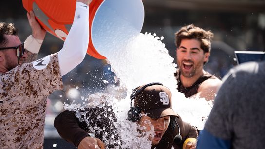 San Diego Padres players Jackson Merrill (3) and Tyler Wade (14) dump water on José Iglesias (7) after a walk-off win against the Kansas City Royals on June 22, 2025 at Petco Park in San Diego, CA. San Diego Padres players Jackson Merrill (3) and Tyler Wade (14) dump water on José Iglesias (7) after a walk-off win against the Kansas City Royals on June 22, 2025 at Petco Park in San Diego, CA.