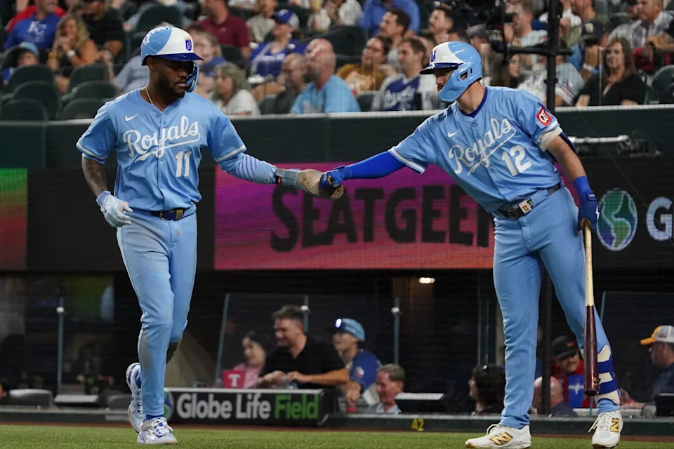 Royals third baseman Maikel Garcia (11) is greeted by outfielder Nick Loftin (12) after scoring against the Rangers.Raymond Carlin III-Imagn Images