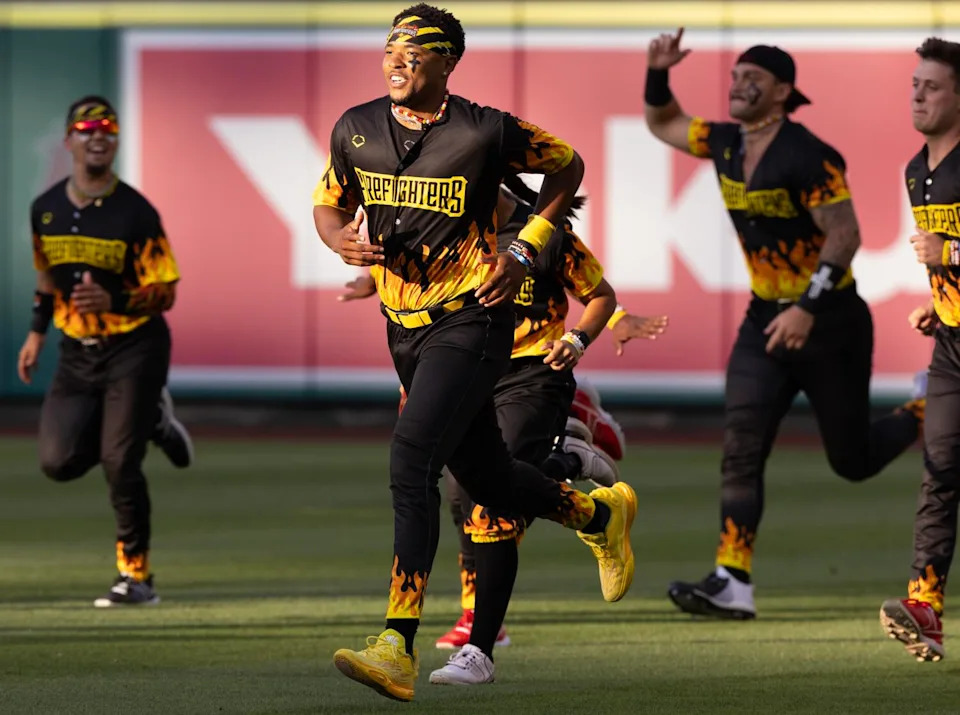 The Firefighters run on the field before taking on the Savannah Bananas.