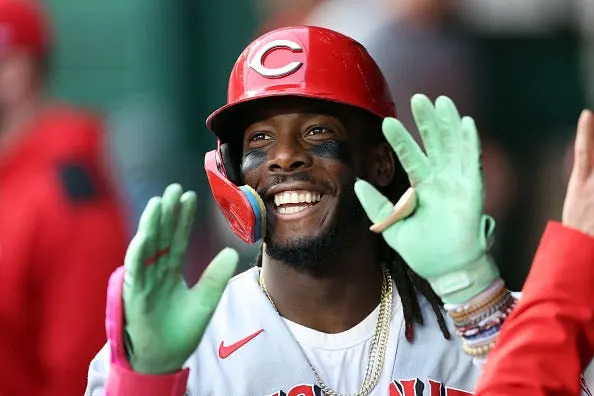 Elly De La Cruz of the Cincinnati Reds is congratulated by teammates in the dugout after hitting a home run against the Kansas City Royals