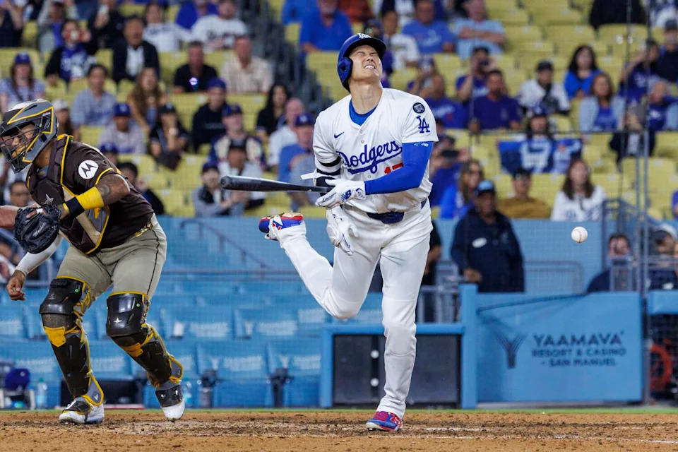 Dodgers star Shohei Ohtani reacts after being hit by a pitch from Padres pitcher Robert Suarez.