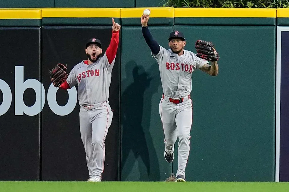 Boston Red Sox center fielder Ceddanne Rafaela (3), right, celebrates catching a fly out against the Detroit Tigers.Junfu Han / USA TODAY NETWORK via Imagn Images