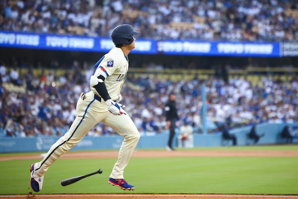 Los Angeles Dodgers designated hitter Shohei Ohtani drops his bat after hitting a home run during the first inning of a baseball game against the San Francisco Giants in Los Angeles, Saturday, June 14, 2025. (AP Photo/Jessie Alcheh)