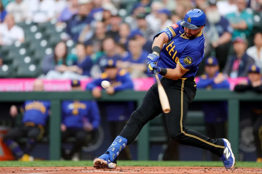 Seattle Mariners’ Cal Raleigh hits a three-run home run that scored J.P. Crawford and Jorge Polanco during the first inning of a baseball game against the Minnesota Twins, Friday, May 30, 2025, in Seattle. Raleigh became the first catcher in MLB history to record 20 home runs before the month of June. (AP Photo/Ryan Sun)