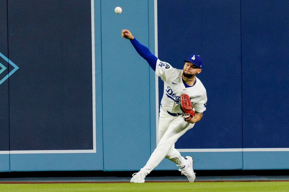 Dodgers outfielder Andy Pages rifles the ball to second base to prevent Arizona's Ketel Marte from advancing.