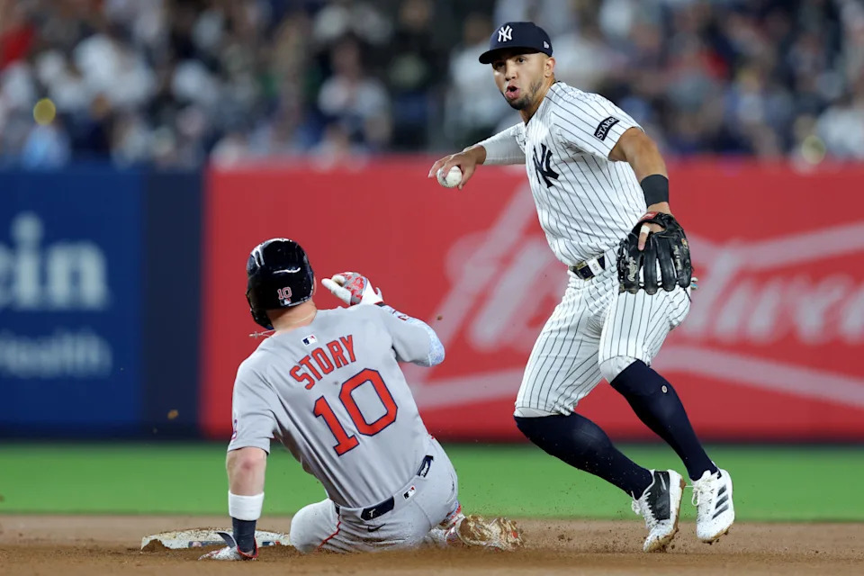 Jun 7, 2025; Bronx, New York, USA; New York Yankees shortstop Oswald Peraza (18) forces out Boston Red Sox shortstop Trevor Story (10) at second base and throws to first to complete a double play on a ball hit by Red Sox center fielder Ceddanne Rafaela (not pictured) during the seventh inning at Yankee Stadium. Mandatory Credit: Brad Penner-Imagn Images© Brad Penner-Imagn Images
