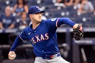 Texas Rangers pitcher Tyler Mahle throws during the first inning of a baseball game against...